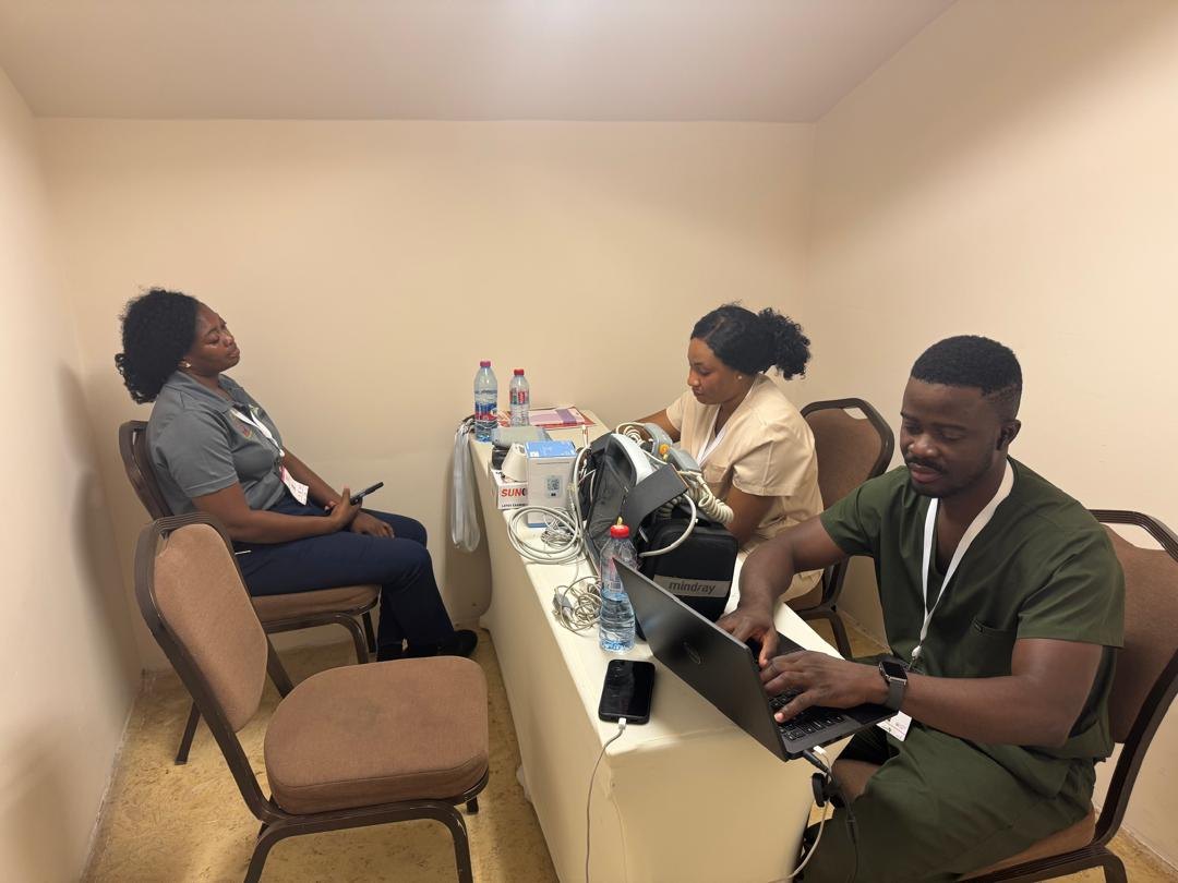 Delegate health screening and blood-pressure checks inside the medic room.